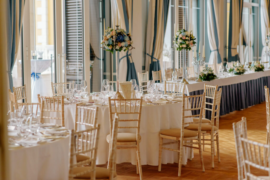 Wedding reception tables with floral centrepieces and candles in Ballroom Teodo at Regent Porto Montenegro.