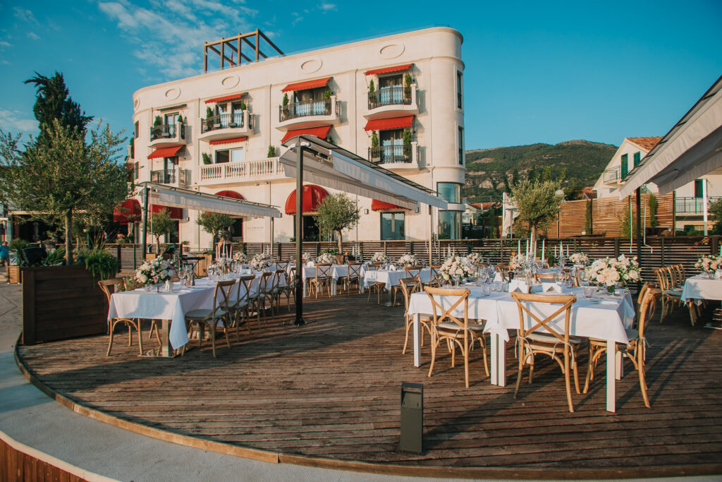 Outdoor wedding reception setup on the wooden terrace at La Roche Hotel in Tivat, Montenegro.