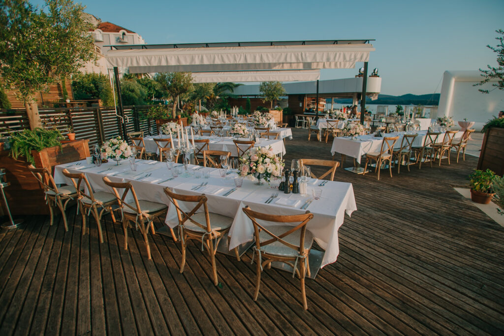 Long dinner tables set on the sea-view terrace at La Roche Hotel, Tivat, Montenegro.