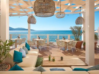 Seaside terrace with pergola seating and open Adriatic views at The Chedi Luštica Bay, Montenegro.