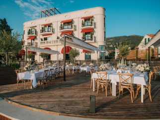 Outdoor wedding reception setup on the wooden terrace at La Roche Hotel in Tivat, Montenegro.