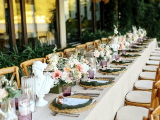 Long wedding dinner table with florals on the terrace at Bocasa Beach & Restaurant, Boka Bay, Montenegro.