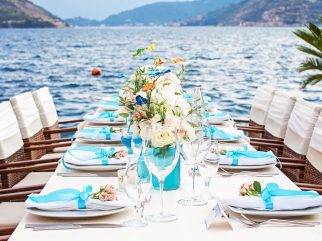 Wedding dinner table on the waterfront terrace at Restaurant Conte in Perast, Bay of Kotor, Montenegro.